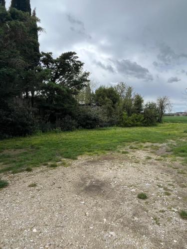 an open field with grass and trees in the background at Maison du Fenouillet in Saint-Gervais-sur-Roubion