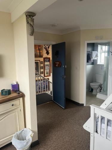 a bathroom with a toilet and a bathroom with a staircase at Hotel Of Wizardry in Great Yarmouth