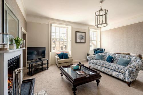 a living room with a couch and a table at Porte House - Holiday At Home in Richmond