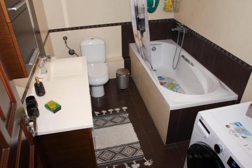 a small bathroom with a tub and a toilet at IDEAL House skopelos in Skopelos Town