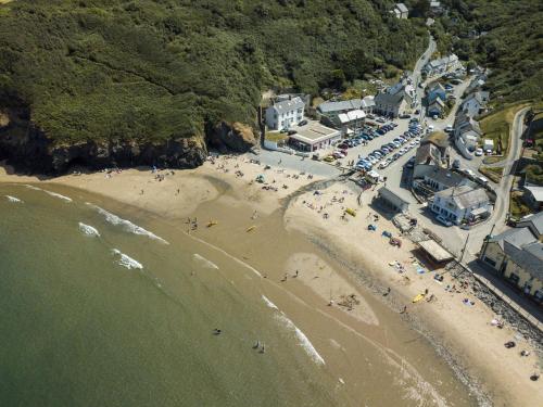 an aerial view of a beach with a crowd of people at Glyncoch Isaf Llangrannog in Llangranog