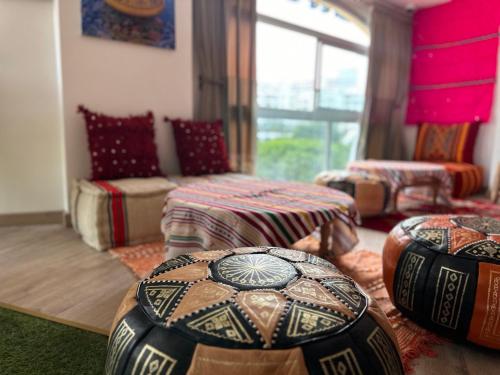 a living room with two ottomans and a couch at La casabella in Tangier