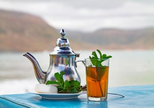 a teapot and a cup of tea on a table at La casabella in Tangier