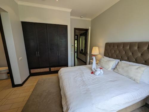 a bedroom with a bed with a stuffed animal on it at Maison La Plage by Simply-Seychelles in Eden Island
