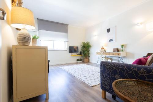 a living room with a couch and a table at beachome4u4 / Carcavelos beach in Parede