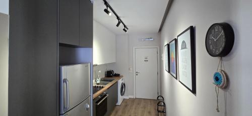 a kitchen with a stainless steel refrigerator and a sink at 3S Apartments -Sea-Sun-Sky- in Sarandë