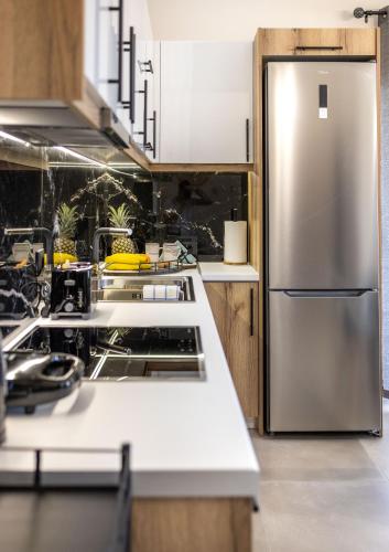 a kitchen with a stainless steel refrigerator at Dina Luxury Sea View House in Aiándion