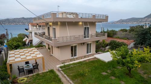 a house with a view of the water at Dina Luxury Sea View House in Aiándion