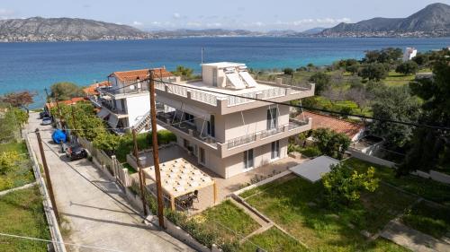an aerial view of a house on the water at Dina Luxury Sea View House in Aiándion
