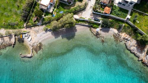 an aerial view of a beach with turquoise water at Dina Luxury Sea View House in Aiándion