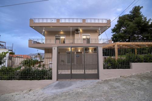a house with a balcony on top of it at Dina Luxury Sea View House in Aiándion