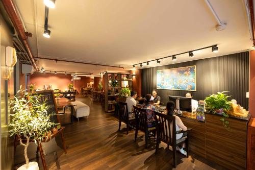 a group of people sitting at a bar in a restaurant at Asian Ruby Hotel Apartment - 122F Bùi Thị Xuân in Ho Chi Minh City