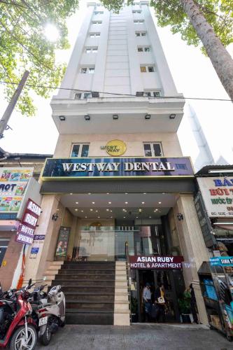 a tall building with a sign in front of a store at Asian Ruby Hotel & Spa - 122F Bui Thi Xuân Street in Ho Chi Minh City
