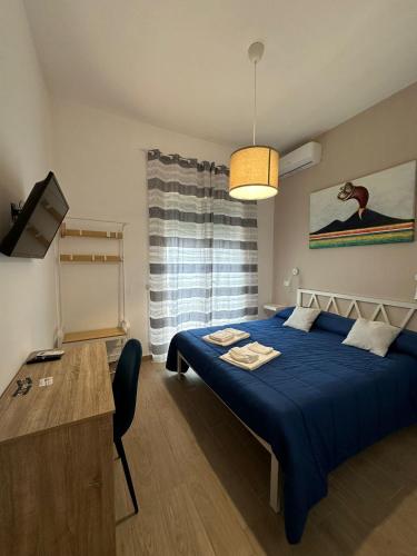 a bedroom with a blue bed with a blue blanket at B&B Zelia Napoli in Naples