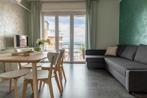 a living room with a couch and a table at Tolle Ferienwohnung in Villaggi mit Eigenem Balkon und Nah am Strand in Castelletto sopra Ticino