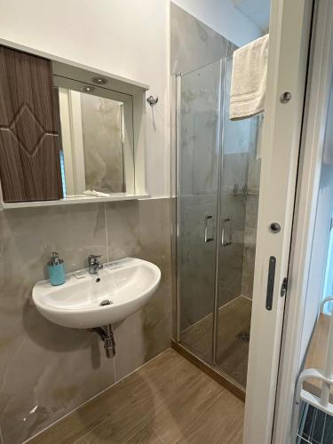 a bathroom with a sink and a shower at B&B Zelia Napoli in Naples
