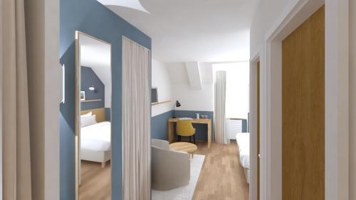 a room with a bedroom with a bed and a mirror at Logis Hôtel de Carantec in Carantec