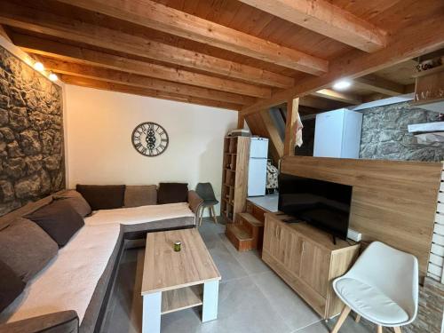 a living room with a couch and a tv at Bay House Kakrc in Tivat