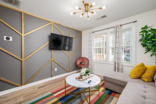 a living room with a couch and a table at Chic 1BD in Sylvan Hills Near Southside Beltline in Atlanta