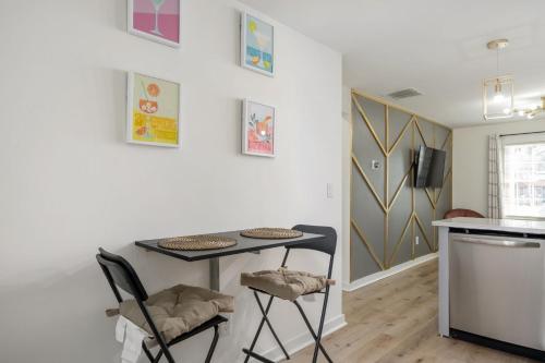 a small kitchen with a table and two chairs at Chic 1BD in Sylvan Hills Near Southside Beltline in Atlanta