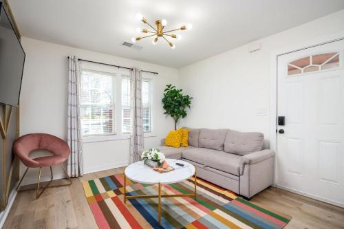 a living room with a couch and a table at Chic 1BD in Sylvan Hills Near Southside Beltline in Atlanta