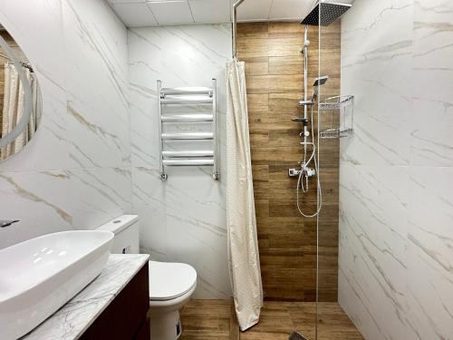 a bathroom with a shower and a toilet at Panoramic City view Apartment with Playstation 5 in Baku