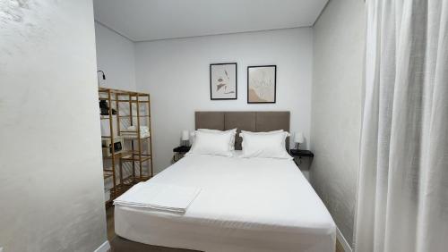 a bedroom with a white bed in a room at 3S Apartments -Sea-Sun-Sky- in Sarandë