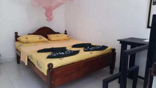 Postel nebo postele na pokoji v ubytování KANTHI GUEST INN