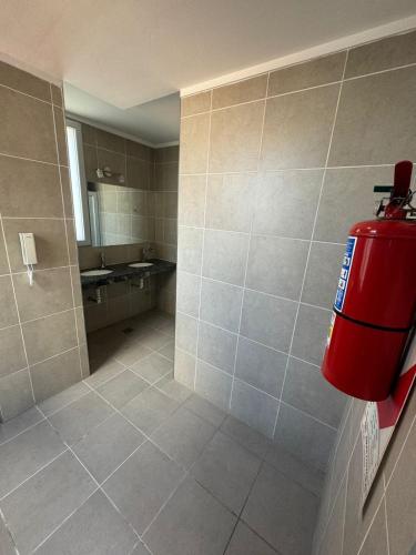 a bathroom with a fire hydrant on the wall at Dpto temporal amueblado con yacuzzi in San Lorenzo