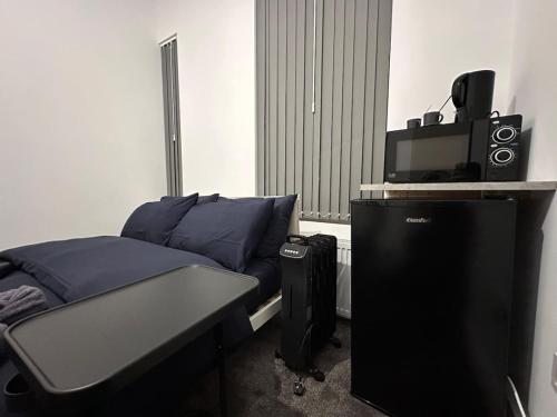 a bedroom with a bed and a television and a speaker at Vauxhall Victoria moments away in London