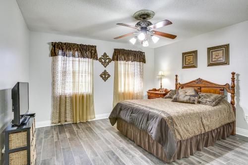 a bedroom with a bed and a ceiling fan at Peaceful Morgan City Home with Docks and Canal Access in Morgan City