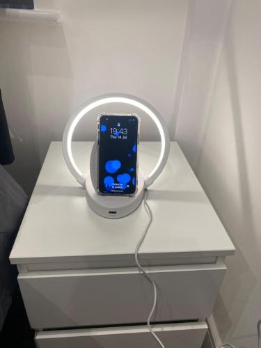 an apple iphone in a holder on a desk at Central London- Zone 1 - Room 3 in London