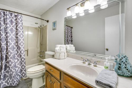 a bathroom with a sink and a toilet and a mirror at Peaceful Morgan City Home with Docks and Canal Access in Morgan City