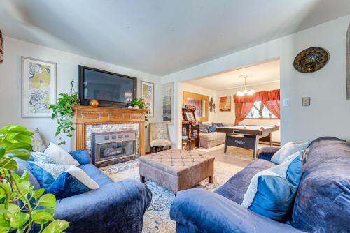a living room with blue couches and a fireplace at Tobyhanna Home with Fire Pit 1 Mi to Lake Carobeth! in Tobyhanna