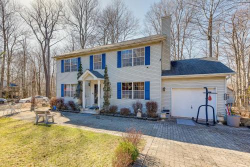 a white and blue house with a driveway at Tobyhanna Home with Fire Pit 1 Mi to Lake Carobeth! in Tobyhanna