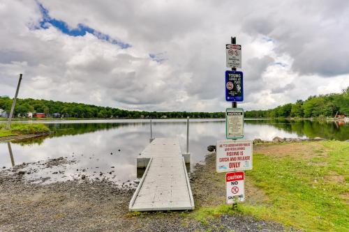a pier in front of a body of water with signs at Tobyhanna Home with Fire Pit 1 Mi to Lake Carobeth! in Tobyhanna