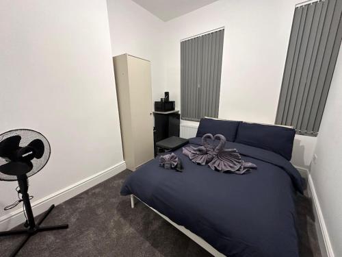 a bedroom with a blue bed with a bow on it at Room in Central London Zone 1 in London