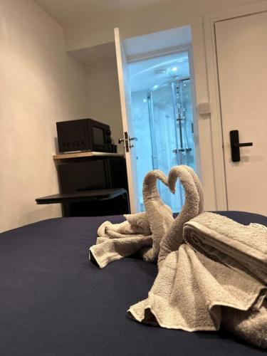 two towel swans sitting on top of a bed at Central London Zone1 Room - Bath in London