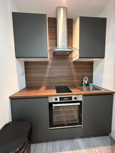 a small kitchen with a stove and a sink at Central London Zone1 Room - Bath in London