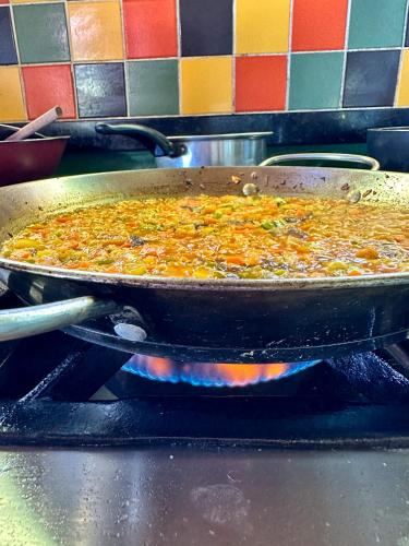 a pizza is cooking in a pan on a stove at Casa Del Mar in Marau