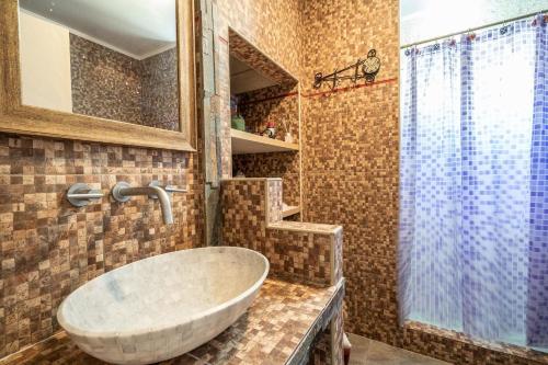 a bathroom with a sink and a shower at Casa en Cariló para 16 personas in Carilo