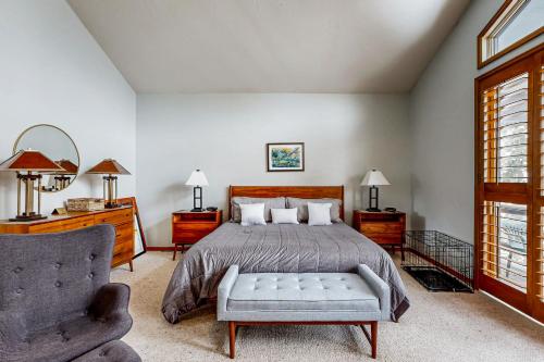 a bedroom with a bed and a couch and a chair at All-Season Chalet in Park City