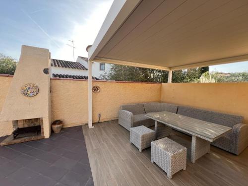 a patio with a bench and a table and a wall at Villa Franca privat pool in L'Estartit