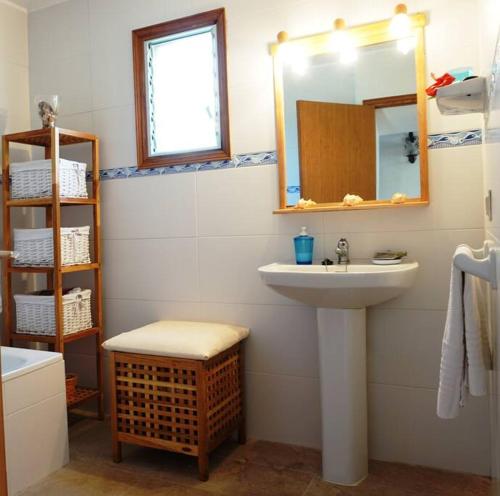 a bathroom with a sink and a mirror at Cozy cottage with private pool , BBQ & Free Wifi in Pollença