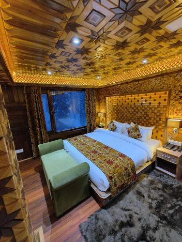 a bedroom with a large bed and a green couch at Hotel Gulmarg Lux Shanum in Gulmarg