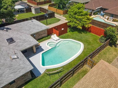 an overhead view of a swimming pool in a backyard at Vibrant Spacious Home w Private Pool and Jacuzzi in Richardson