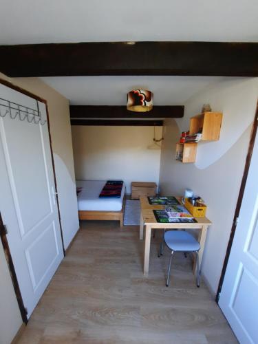 a room with a desk and a bed and a table at Biert La Coume in Biert