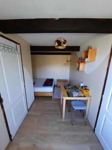 a room with a desk and a bed and a table at Biert La Coume 2 persoonsbed in Biert