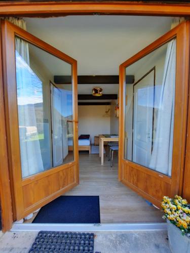 a room with sliding glass doors and a table at Biert La Coume in Biert
