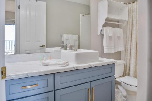 a white bathroom with a sink and a toilet at The Palms 314 in Orange Beach